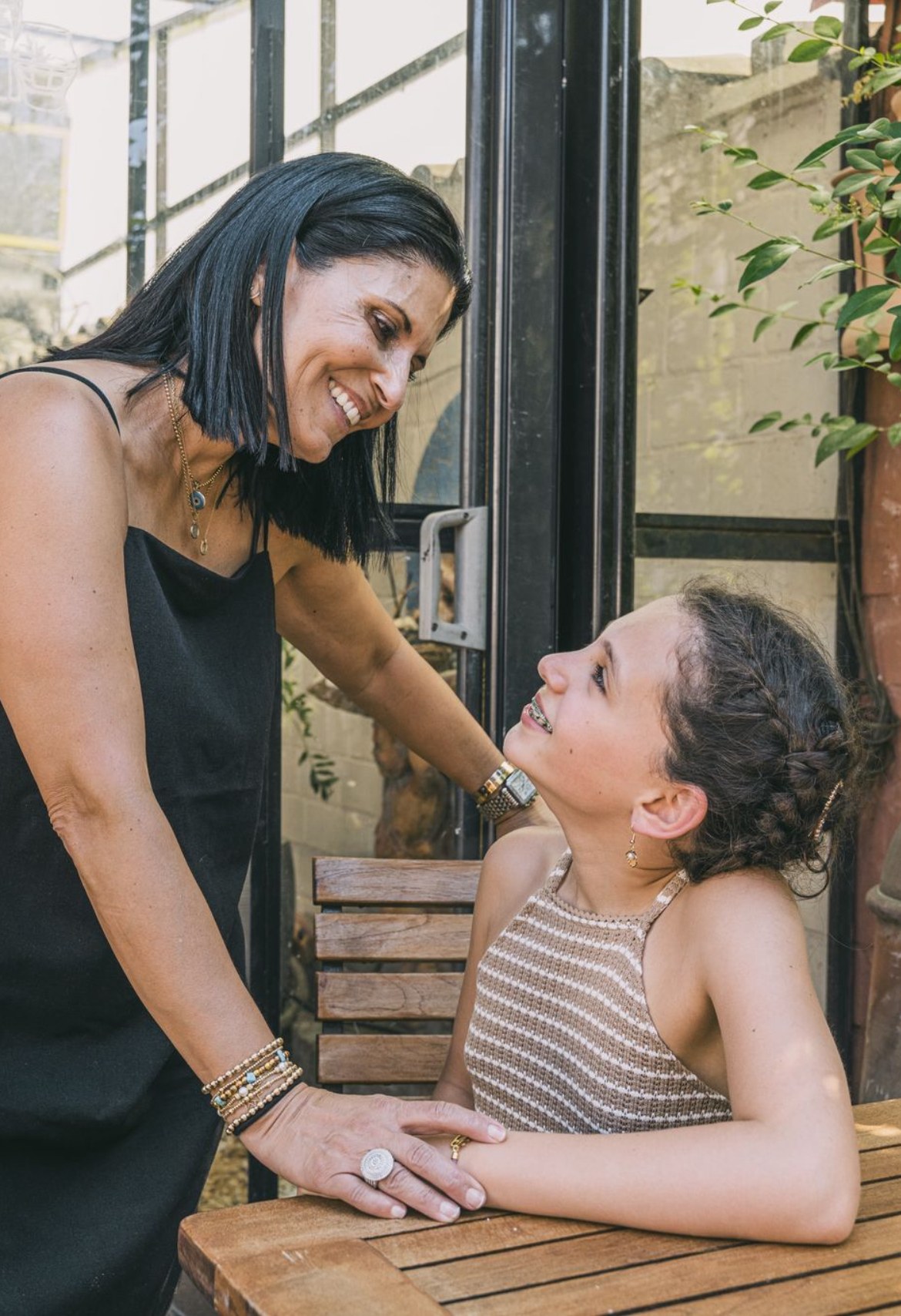 Diana sharing a smile with a young student